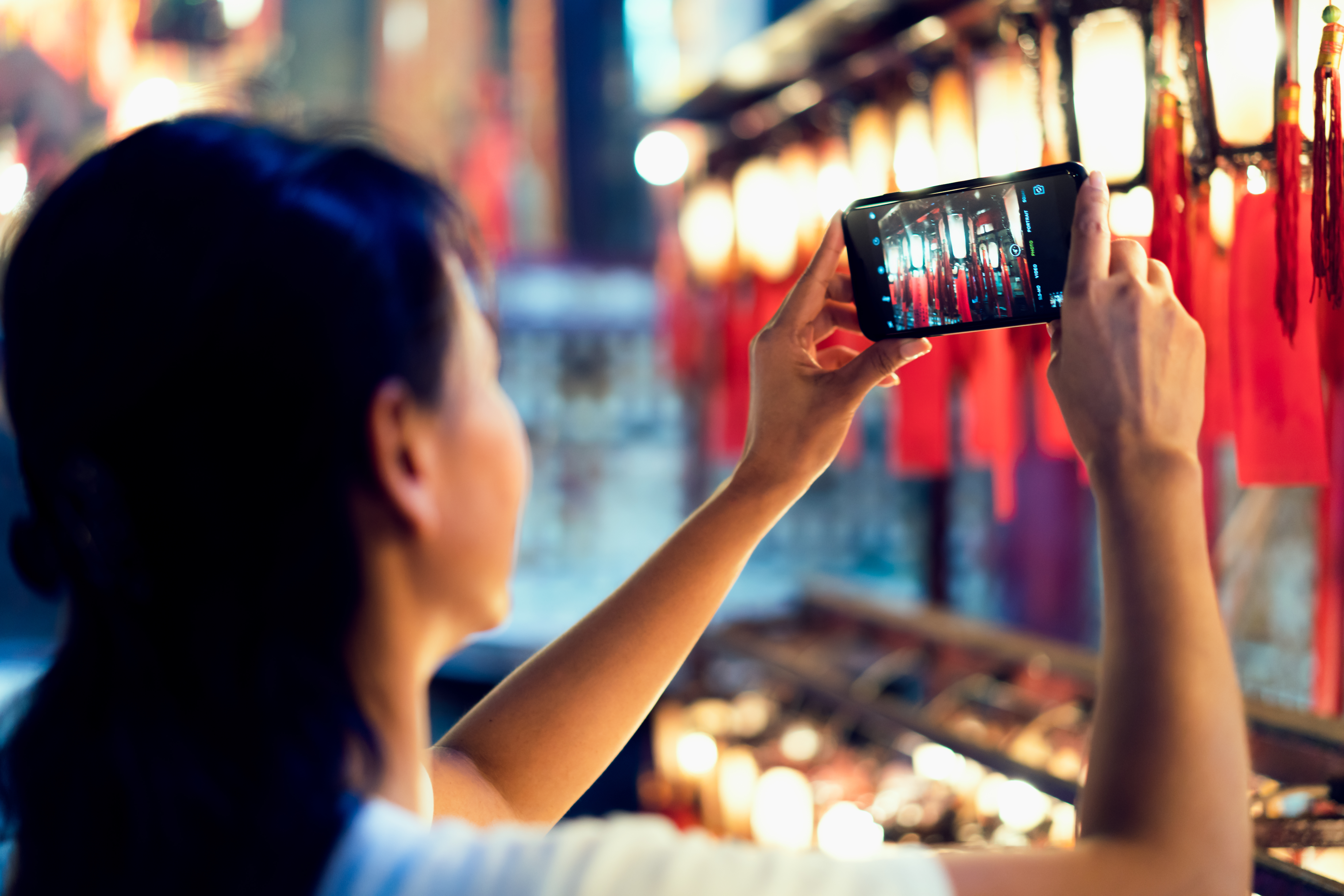 Woman taking picture with smartphone of  beautiful lamp photo at Hong Kong